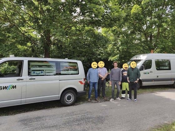 Project team next to an SWM utility vehicle after field work